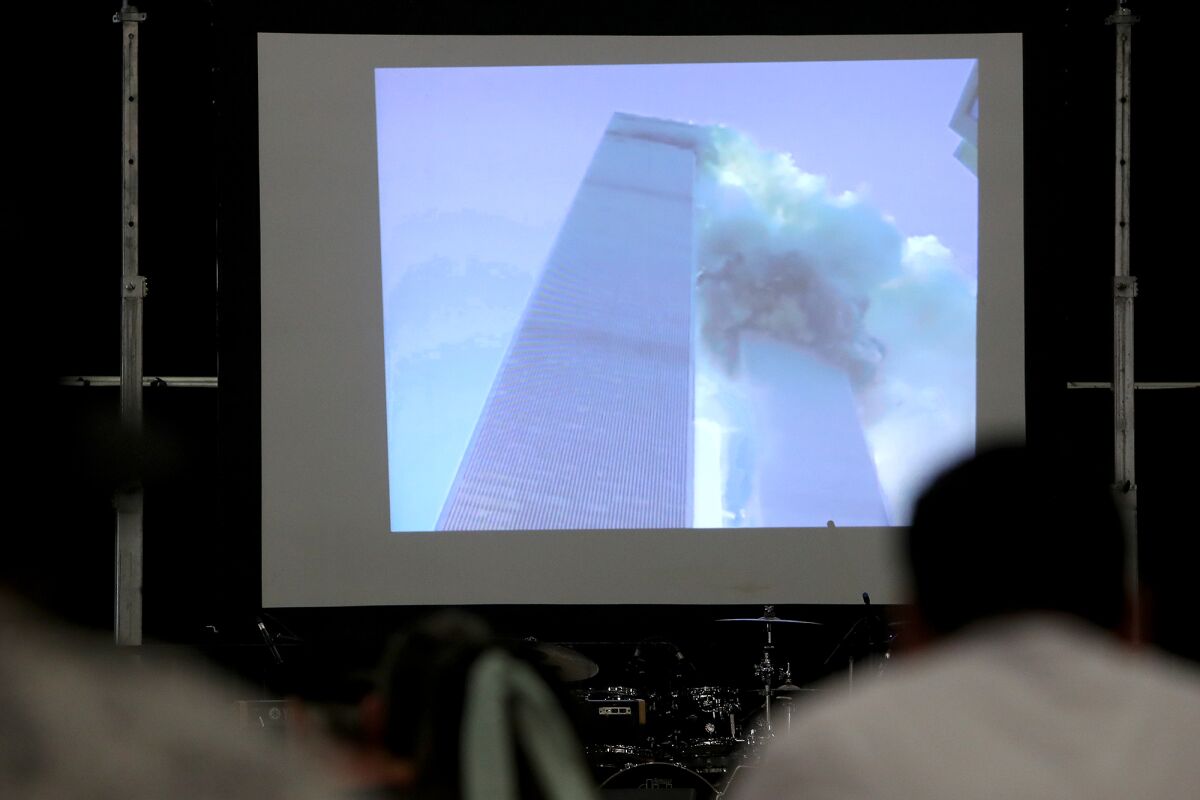 An image of the World Trade Center South Tower collapsing is shown in a video presentation.