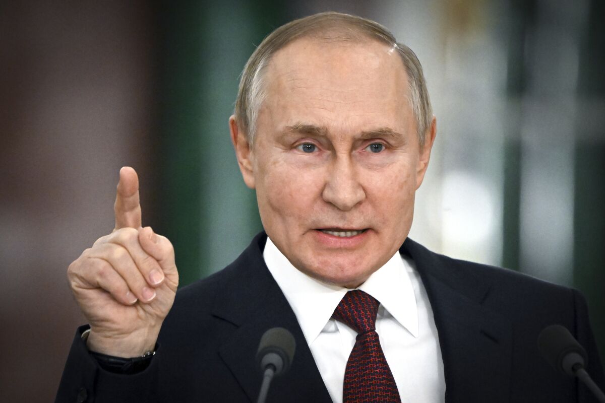Russian President Vladimir Putin pointing a finger upward