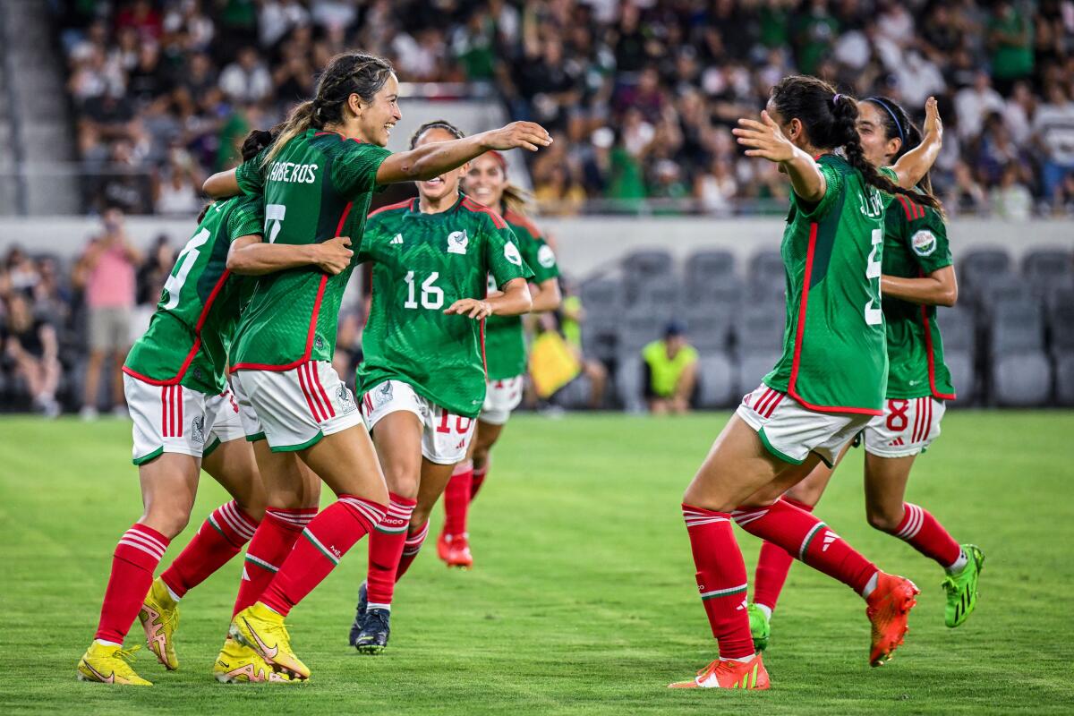 Mexico's Scarlett Camberos, second from left, celebrates with teammates after scoring a goal against Angel City.