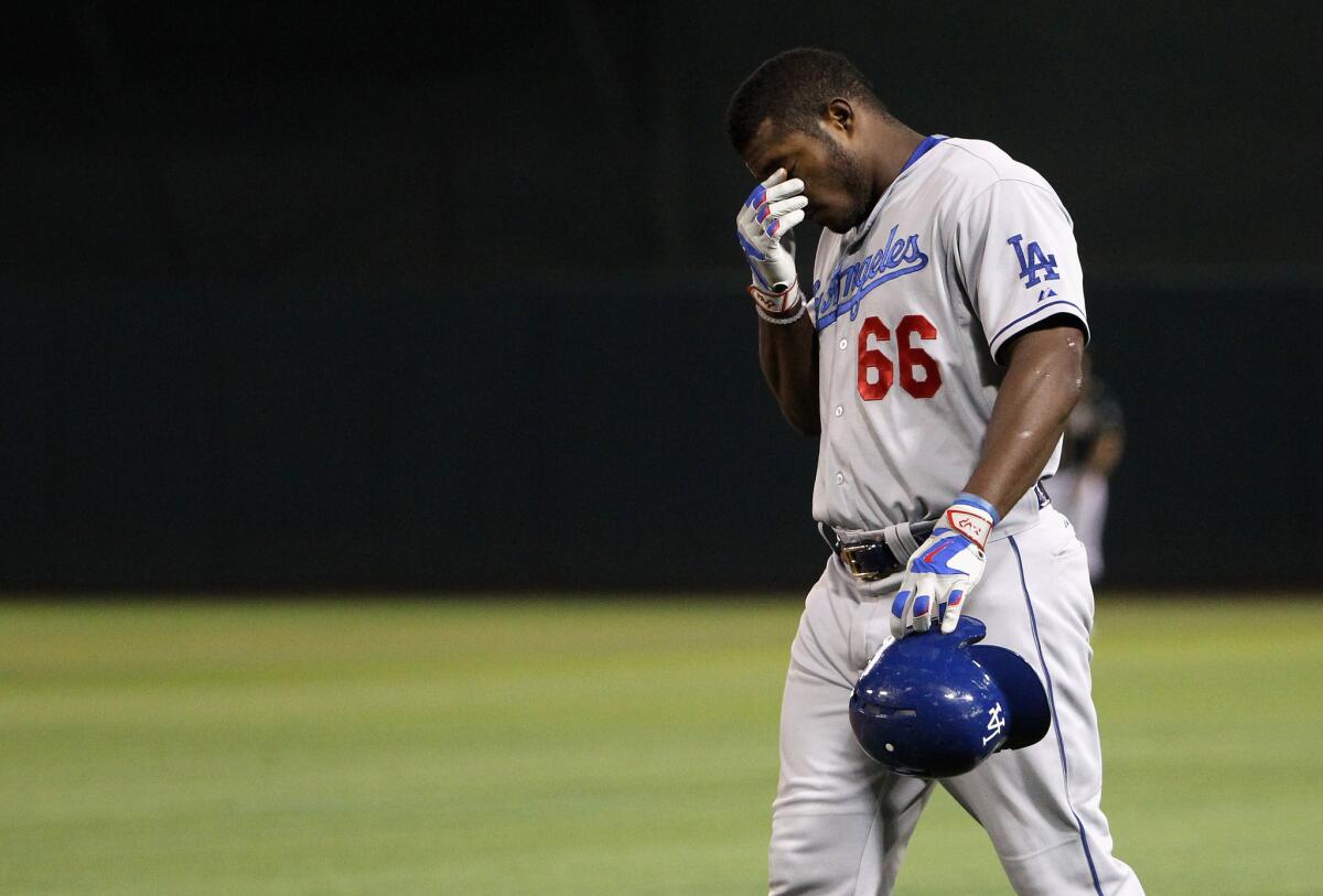 Dodgers outfielder Yasiel Puig reacts after hurting himself in the eighth inning against the Athletics.