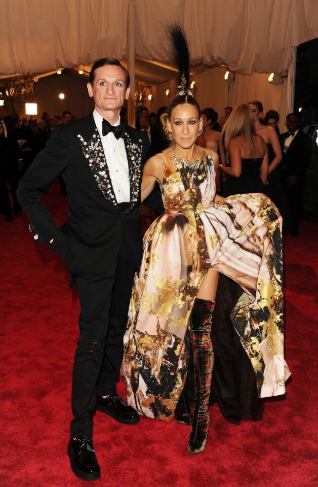 Hamish Bowles and Sarah Jessica Parker. Parker is wearing a Giles Deacon dress, Philip Treacy punk couture hat, Fred Leighton and Repossi jewelry, Giles Deacon bag, and Louboutin boots.
