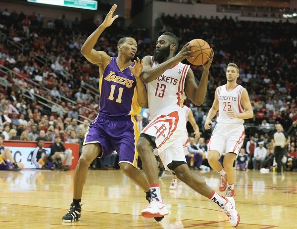 Houston Rockets guard James Harden tries to drive past Lakers forward Wesley Johnson.