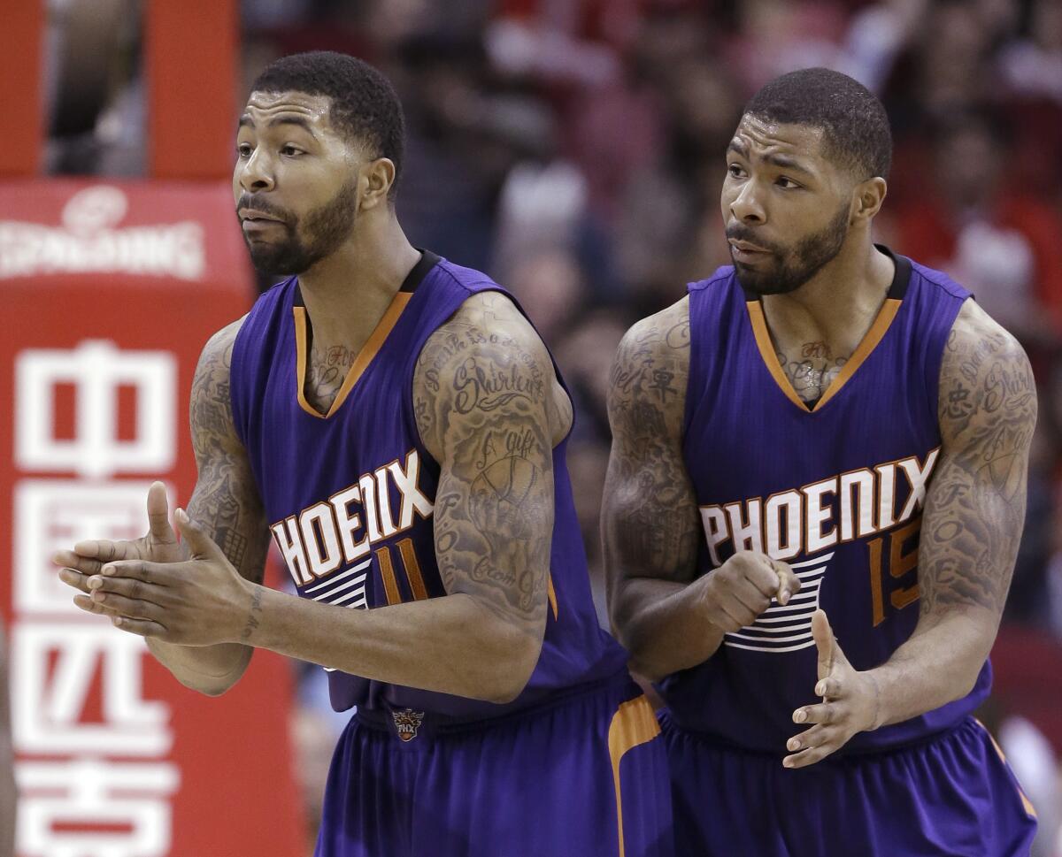 Phoenix Suns Markieff Morris and Marcus Morris talk to a referee.