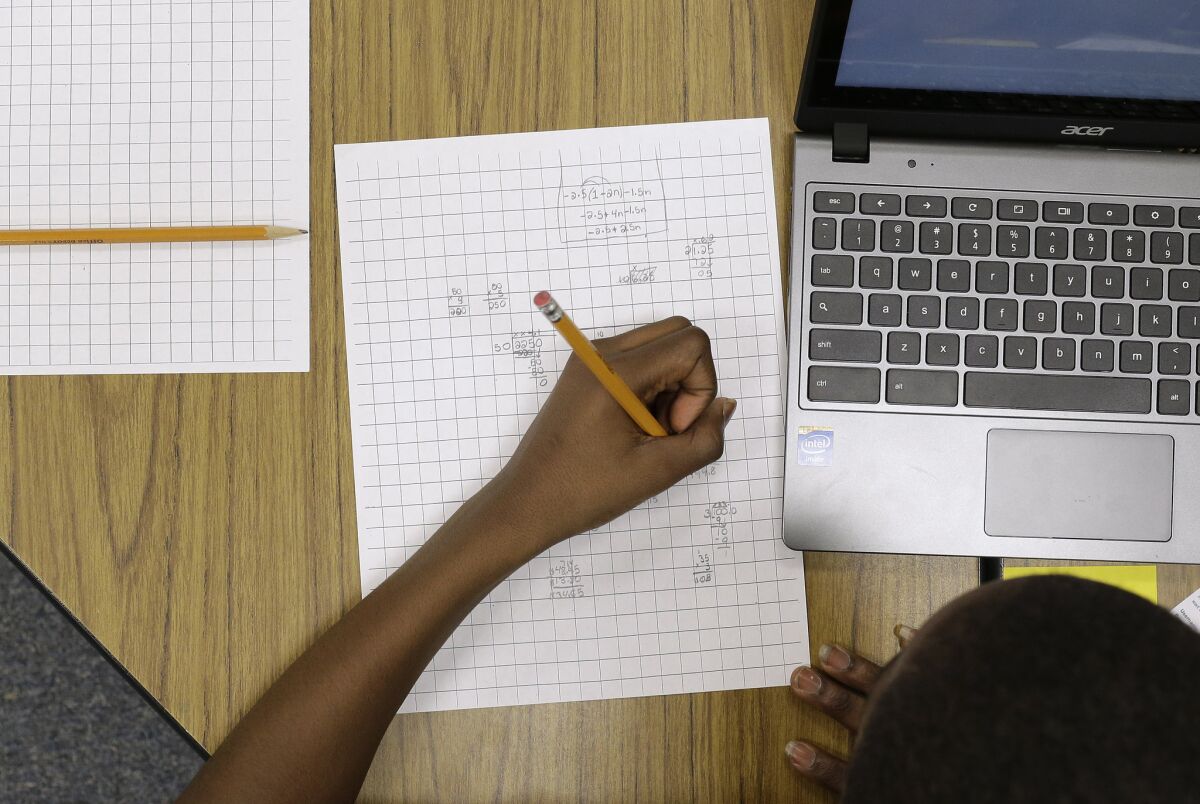 Yamarko Brown, age 12, works on math problems as part of a trial run of a new state assessment test at Annapolis Middle School in Annapolis, Md.