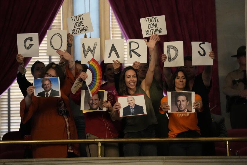 People in the gallery hold signs over the House chamber floor during a legislative session Thursday, April 25, 2024, in Nashville, Tenn. (AP Photo/George Walker IV)