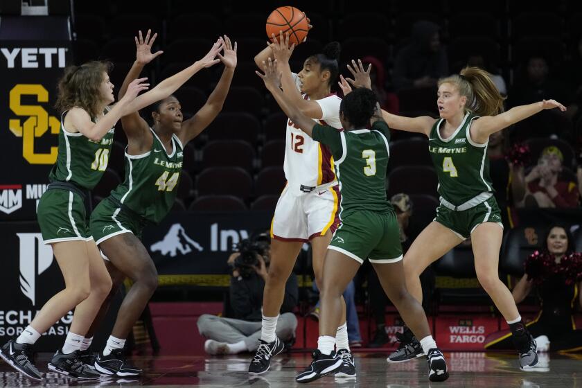 Southern California guard JuJu Watkins (12) is defended by Le Moyne guard Sydney Lusher.