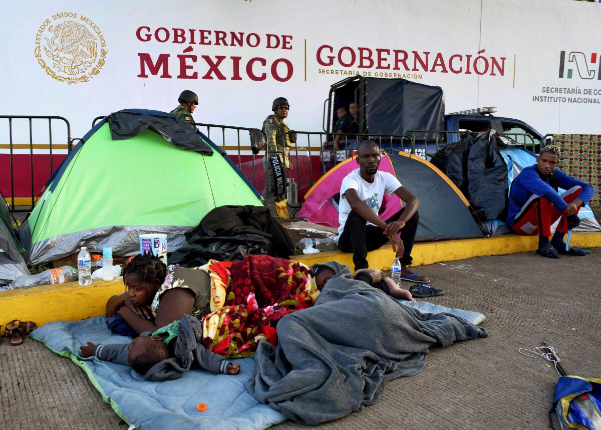 African migrants rest outside the Siglo XXI migrants detention center, as they wait for humanitarian visas that enable them to cross Mexico on their way to the US, in Tapachula, Chiapas state, Mexico, in teh border with Guatemala, on August 28, 2019.