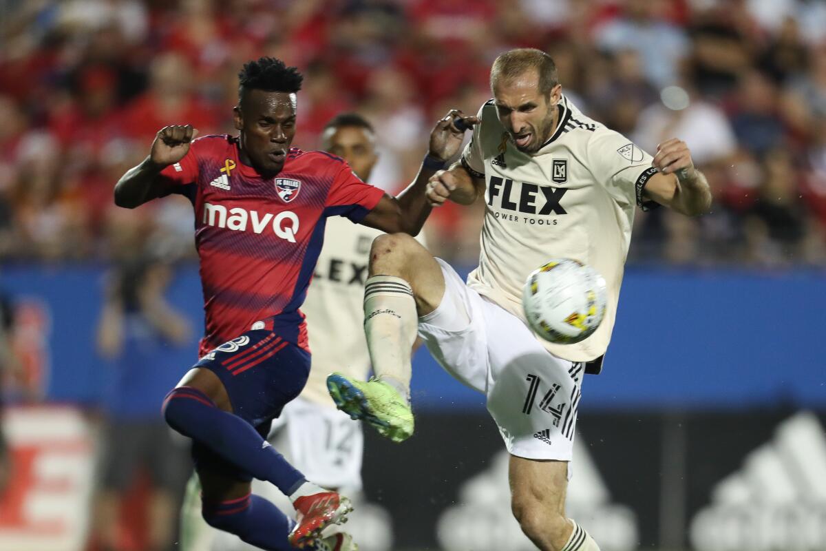 LAFC's Giorgio Chiellini and FC Dallas' Jader Obrian battle for the ball during LAFC's 2-1 loss Saturday night.