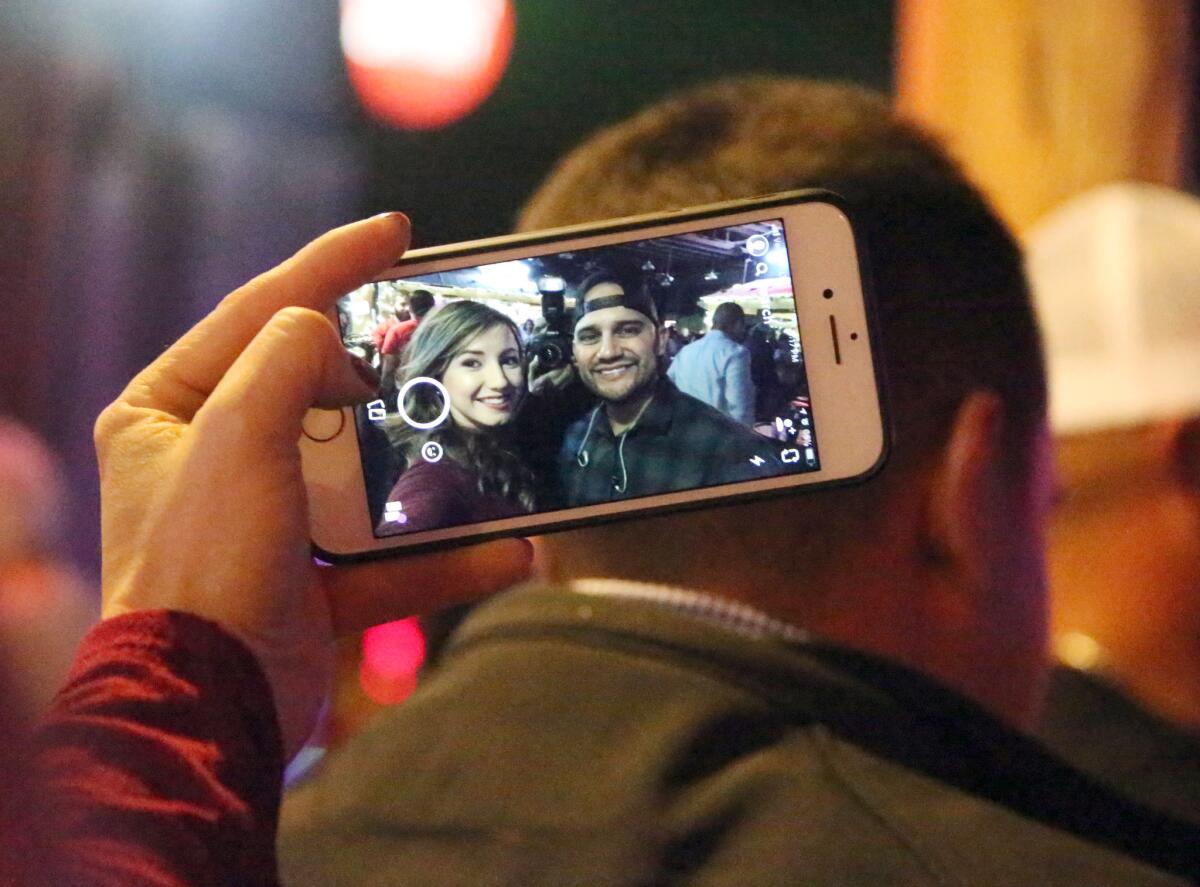 Frank Ray poses for a selfie with fan and former co-worker Stephanie Carabajal at Whiskey Dicks nightclub.
