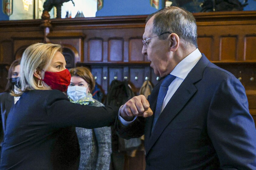 In this handout photo released by Russian Foreign Ministry Press Service, Russian Foreign Minister Sergey Lavrov, right, and British Foreign Secretary Liz Truss greet each other prior to their talks in Moscow, Russia, Thursday, Feb. 10, 2022. Britain's top diplomat has arrived in Moscow to try to defuse tensions raised by Russia's military buildup near Ukraine. (Russian Foreign Ministry Press Service via AP)