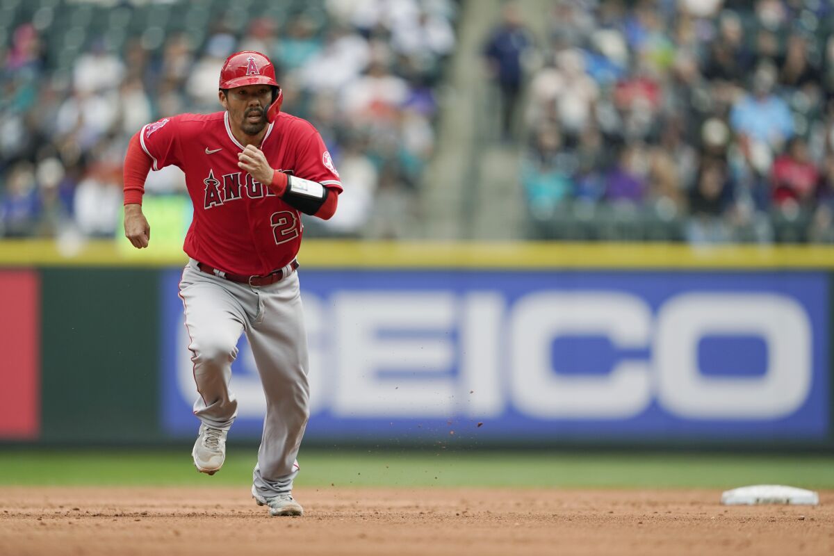 Angels' Kurt Suzuki takes off from second base as Angels' Tyler Wade lines out to end the top of the fourth inning.