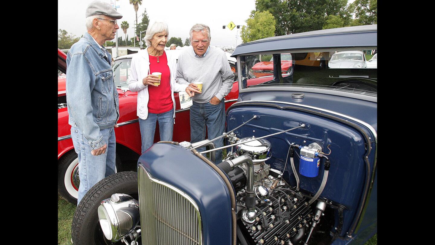 Scott Cappiello, of Shadow Hills, Sue MacKenzie, and David Frandsen, of La Cañada Flintridge, look over and Ford Model A at Fiesta Days at Memorial Park in La Cañada Flintridge on Saturday, May 28, 2016. The three-day event includes a breakfast, and a classic car show, all sponsored by the La Cañada Chamber of Commerce and Community Association.