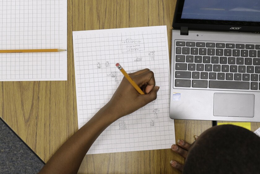 Yamarko Brown, 12, works on math problems as part of a trial run of a new state assessment test at Annapolis Middle School in Md.