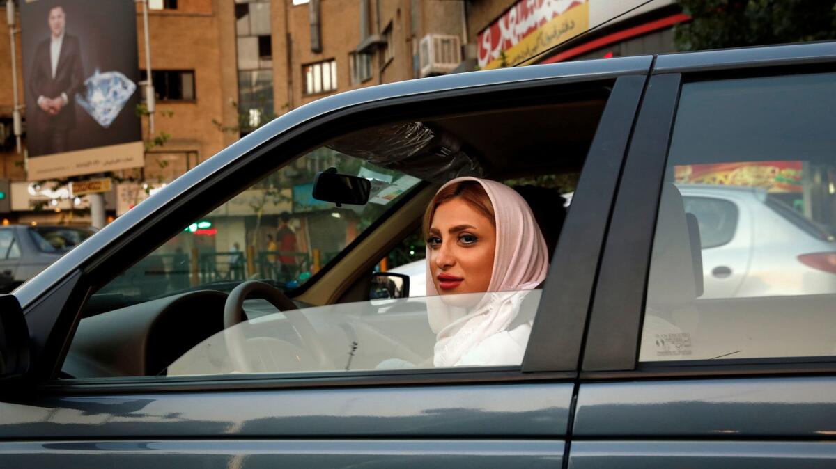 Iran's judiciary has said women must wear the mandatory head covering even in cars. Opponents argue the car is a private space.