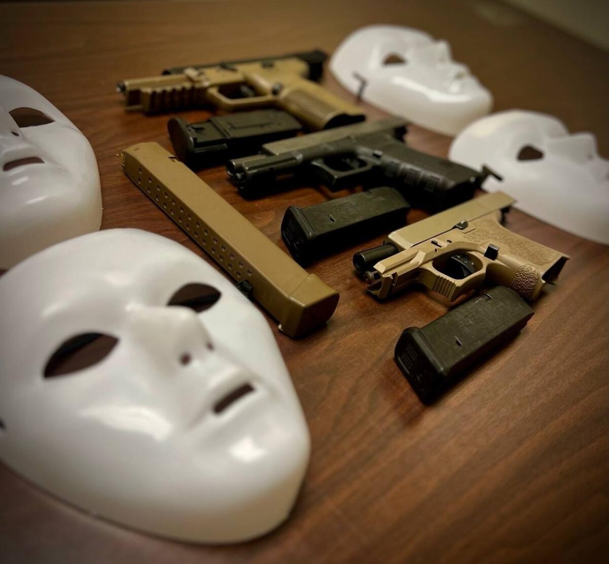 Weapons and white masks on a table.