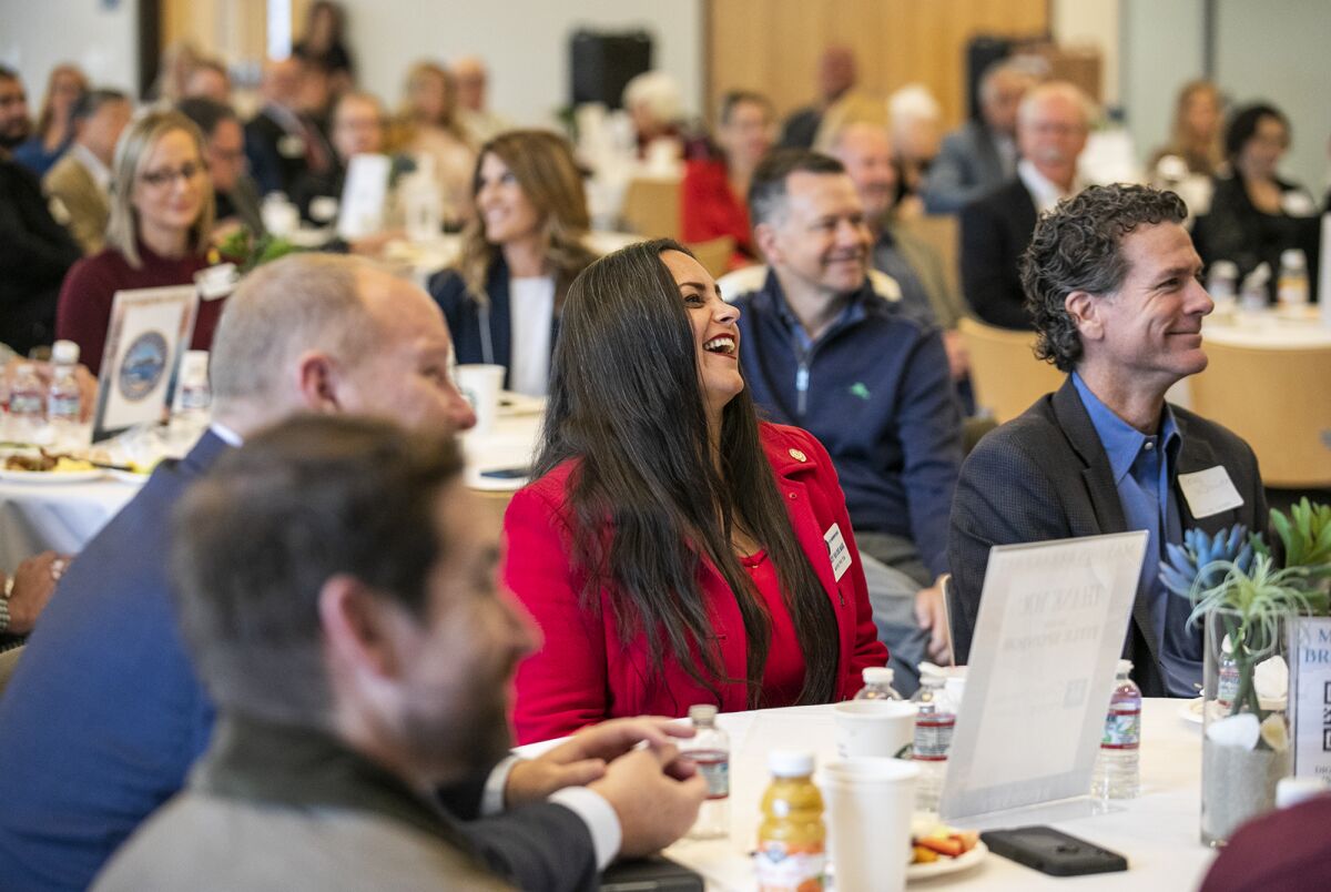 Huntington Beach Mayor Pro Tem Gracey Van Der Mark laughs as Mayor Tony Strickland mentions her during his remarks Thursday.