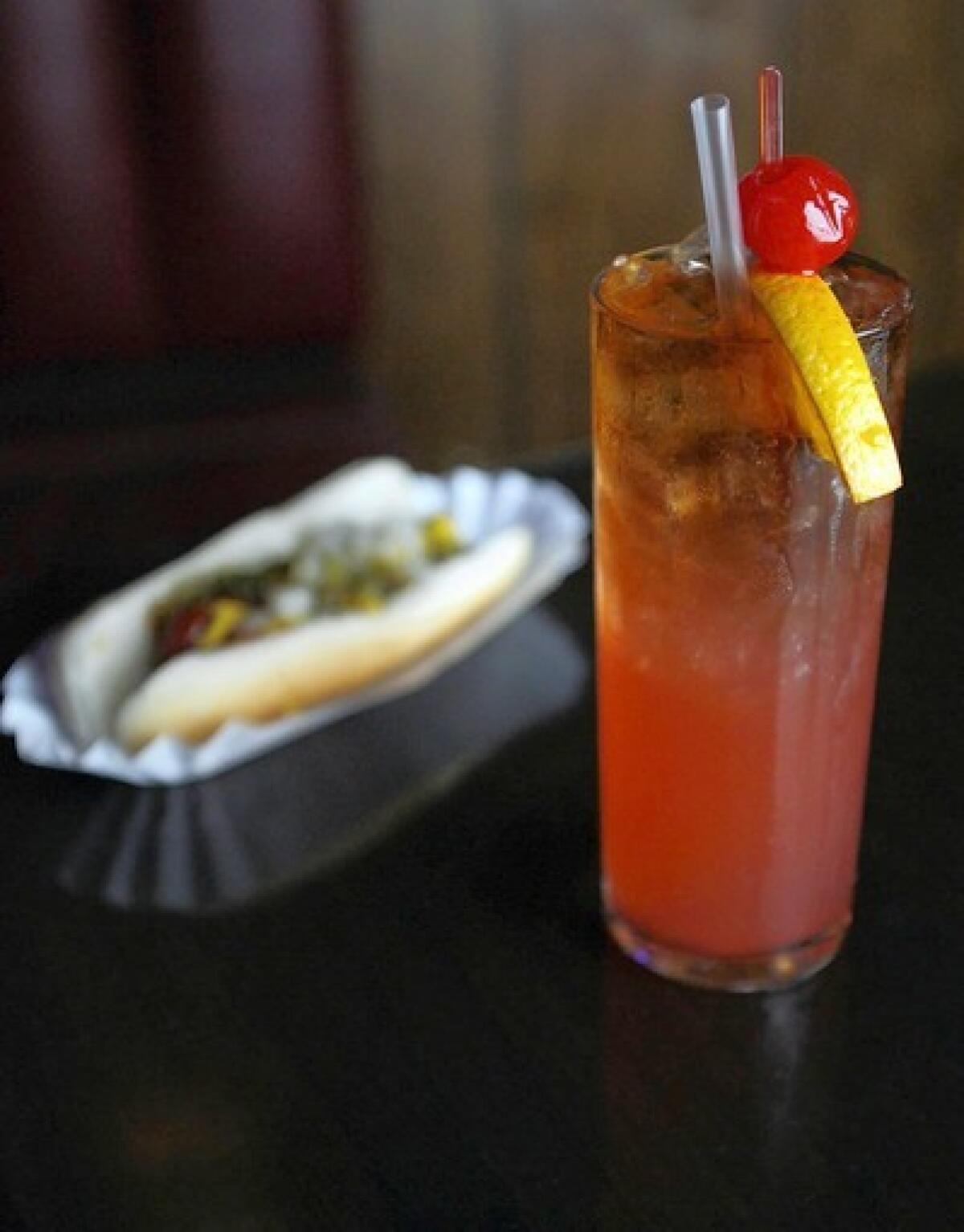 Customers can enjoy happy hour drink specials at Dave's in Glendale. Complimentary hot dogs are offered from 4 p.m. to 7 p.m. Patrons can have $3 well drinks and $1 off on domestic beers. This cocktail, as pictured, is a mix of rum, pineapple juice and cherry grenadine.