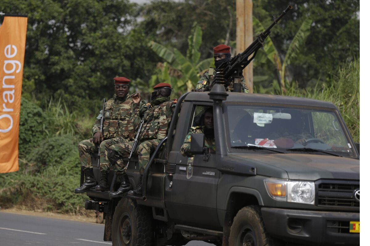 Soldiers patrol outside the entrance of Bafoussam stadium ahead of the African Cup of Nations 2022 group B soccer match between Senegal and Guinea at the Bafoussam Omnisport Stadium, Bafoussam, Cameroon, Friday, Jan. 14, 2022. (AP Photo/Sunday Alamba)