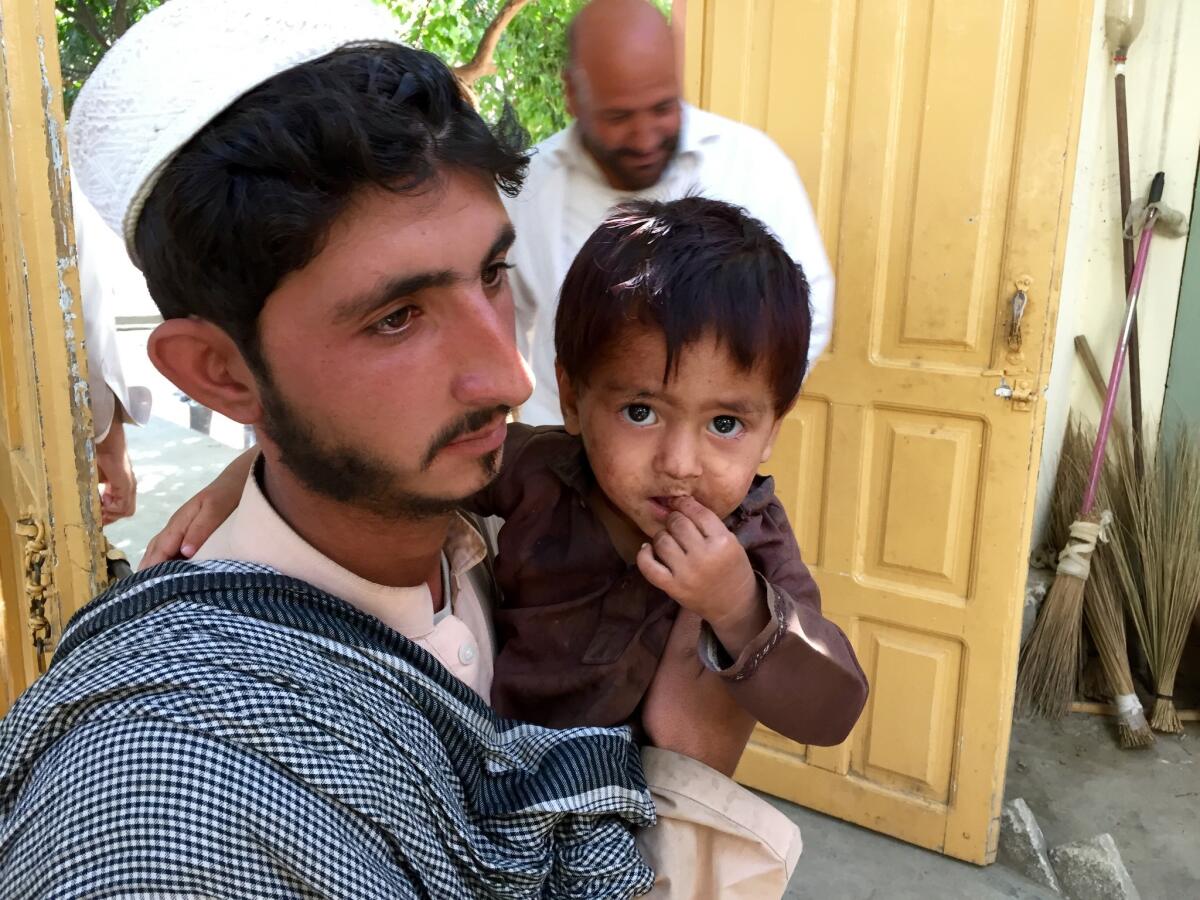 Zainullah, pictured with his uncle Mosanif, is one of four children from Afghanistan's remote Sheltan valley to be paralyzed by polio in 2016.