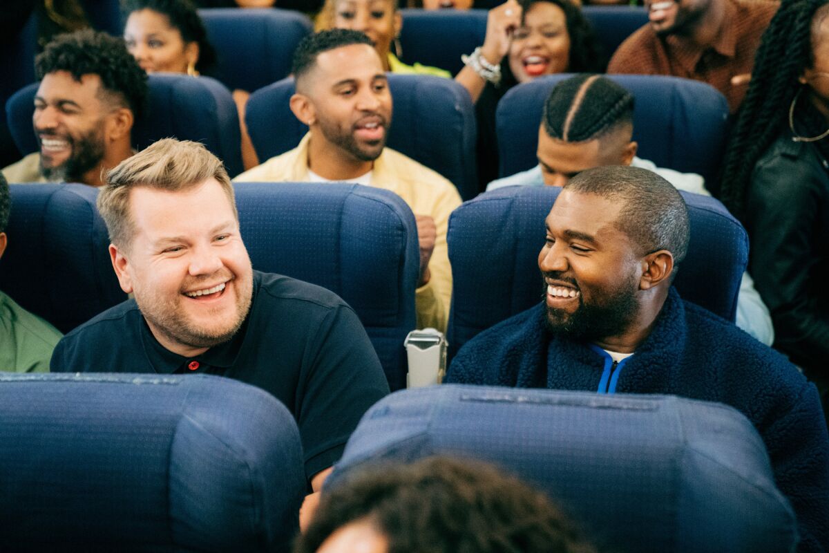 "Late Late Show" host James Corden, left, joins rapper Kanye West for "Airpool Karaoke" with West's Sunday Service choir.