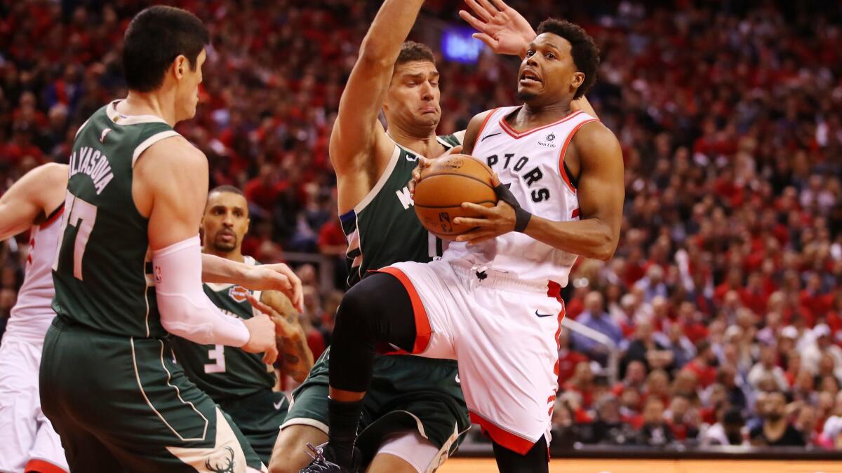 Toronto Raptors' Kyle Lowry (7) drives to the basket during the second half against the Milwaukee Bucks in Game 4 of the NBA Eastern Conference finals on Tuesday.