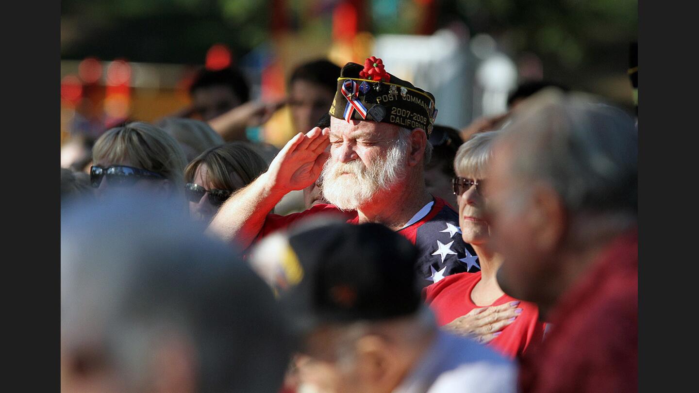 Warren Spayth, of the Marine Corp., salutes the American Flag during the Pledge of Allegiance at Two Strike Park in La Crescenta on Veteran's Day, Friday, November 11, 2016. Congressman Adam Schiff spoke, and the ceremony recognized women in the military.
