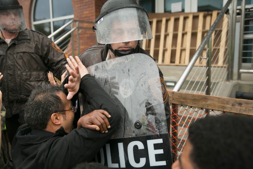Demonstrators confront officers outside the Ferguson, Mo., police station this week.