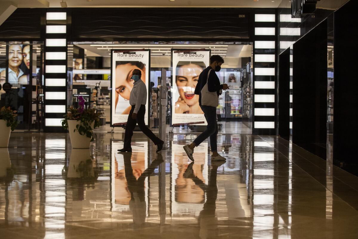 Masked shoppers at a mall.