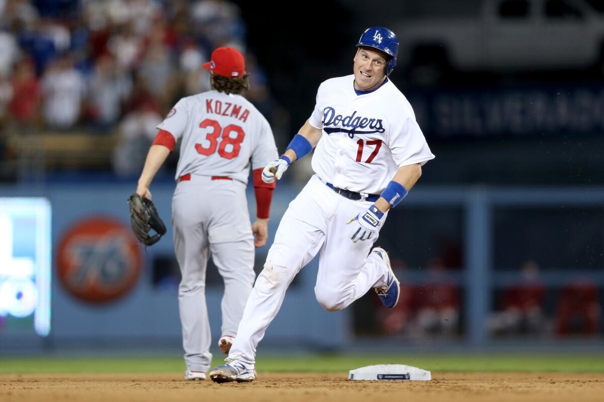 Dodgers catcher A.J. Ellis rounds second base on his way to a triple in the Dodgers' 3-0 win over the St. Louis Cardinals in Game 3 of the National League Championship Series on Monday. Ellis was rewarded for his faith in third base coach Tim Wallach on the hit.