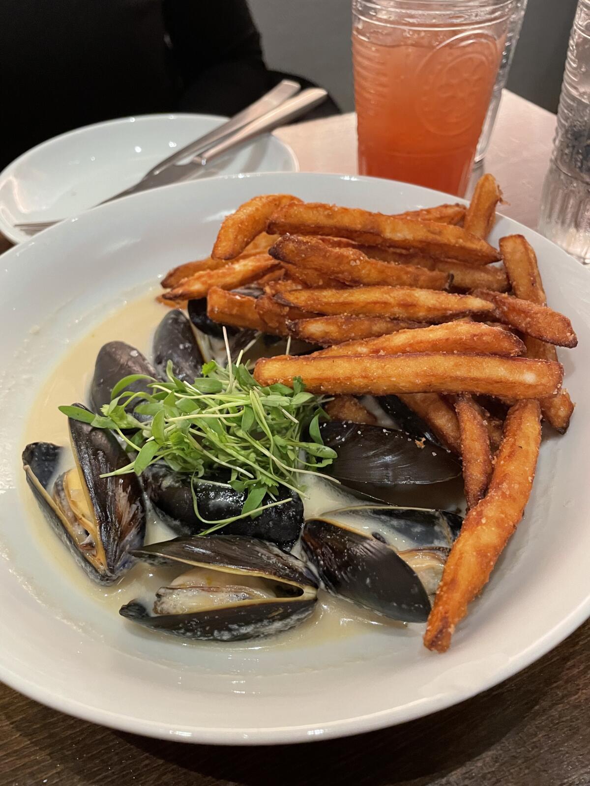 Crisp fries can be added on to the steamed PEI mussels in green curry to make them “moule-frites”.