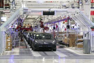 In this photo released by China's Xinhua News Agency, Tesla vehicles are seen on an assembly line at Tesla's gigafactory in Shanghai, Tuesday, Jan. 7, 2020. Tesla's Shanghai factory delivered its first cars to customers Monday, and chief executive Elon Musk said the electric automaker plans to set up a design center in China to create a model for worldwide sales. (Ding Ting/Xinhua via AP)
