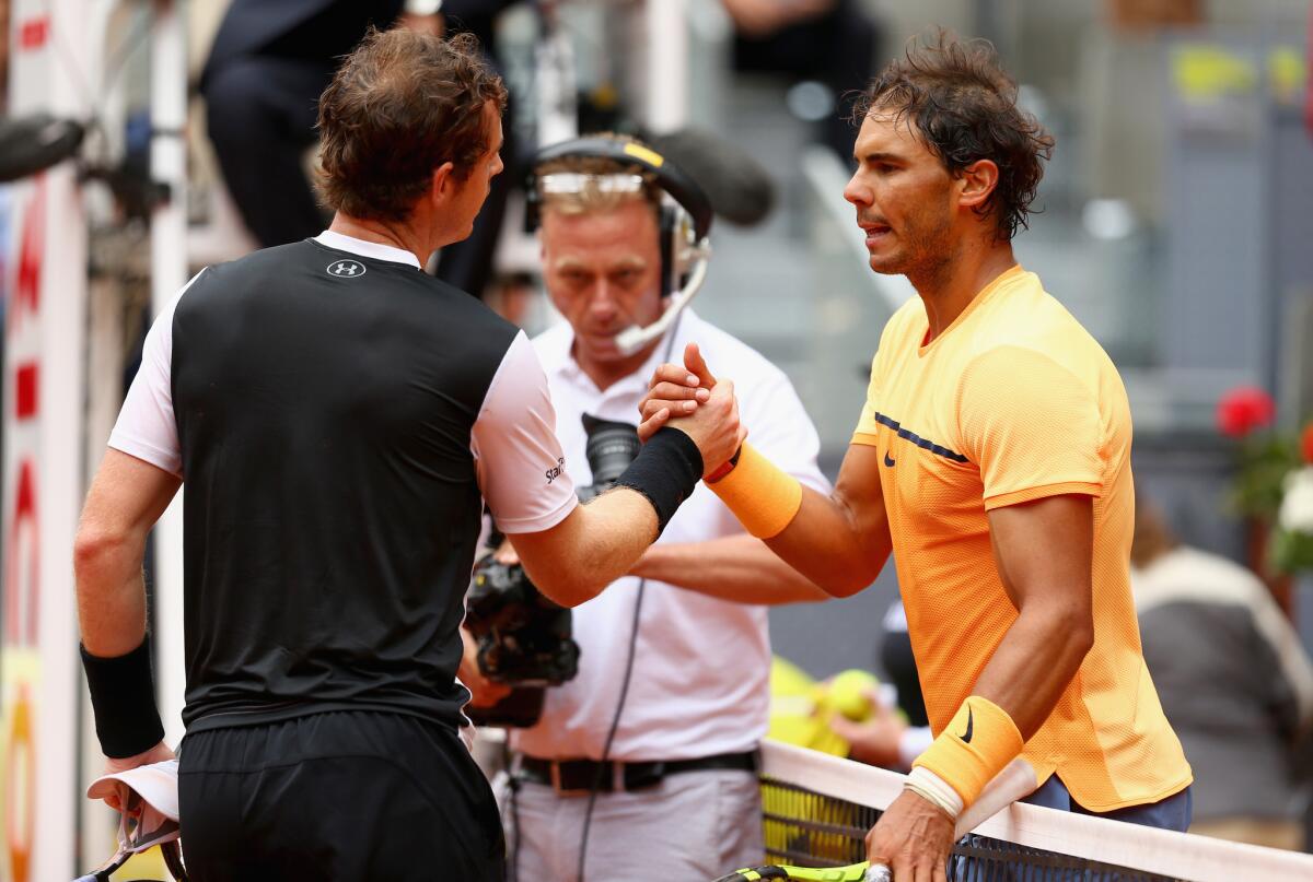 Andy Murray, left, receives congratulations from Rafael Nadal after winning their Madrid Open semifinal match on Saturday.