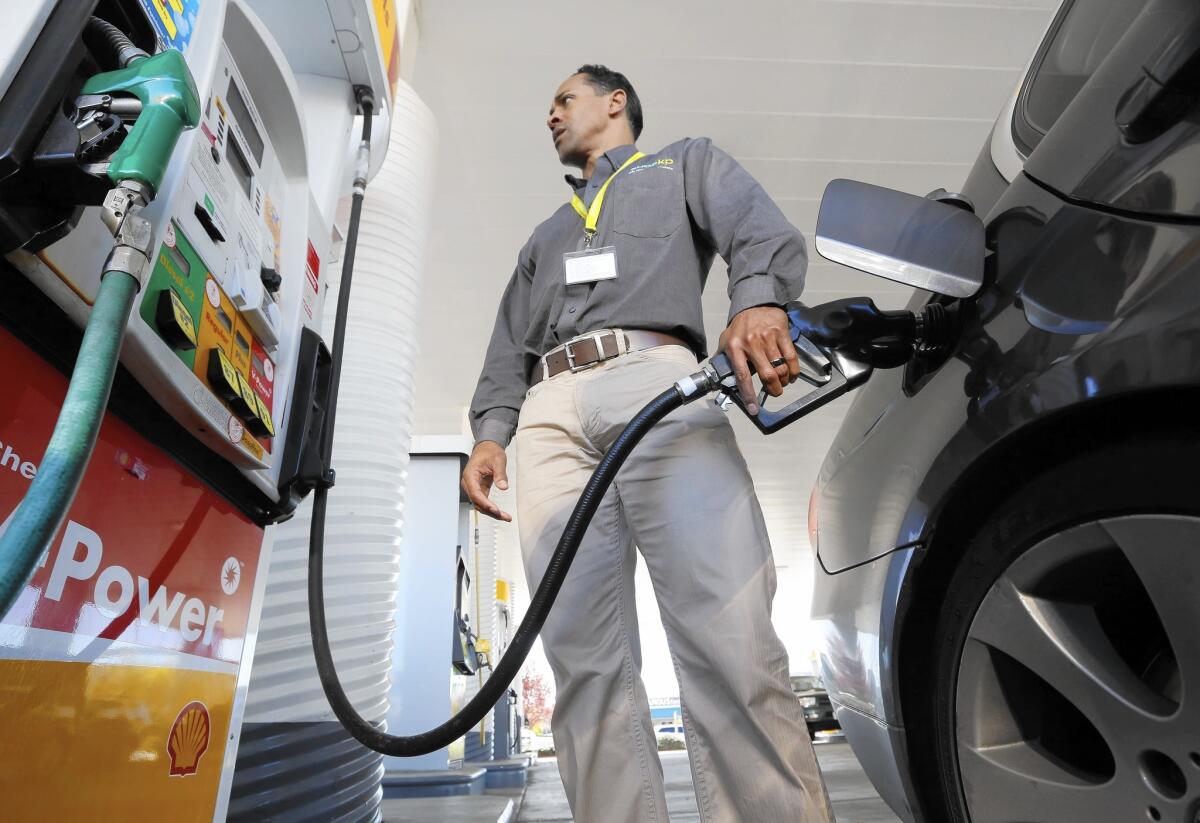 California's 30-cent-a-gallon excise tax on gasoline will drop to 27.8 cents July 1 as a result of a 3-2 vote by the state Board of Equalization. Above, Eric Henry buys gas in Sacramento in March 2014.