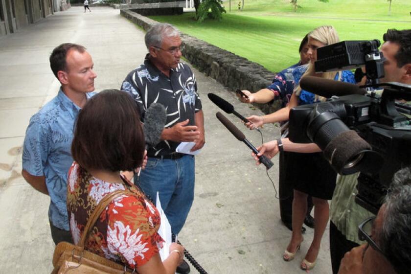 Chairman William Aila of the Hawaii Department of Land and Natural Resources, center, speaks to reporters at a news conference in Honolulu on Tuesday.