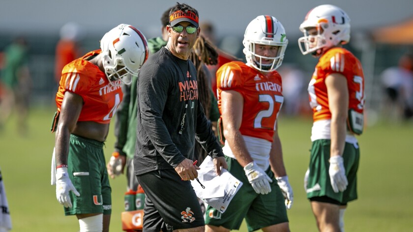 Miami offensive coordinator Dan Enos instructs his players during a practice session on July 29.