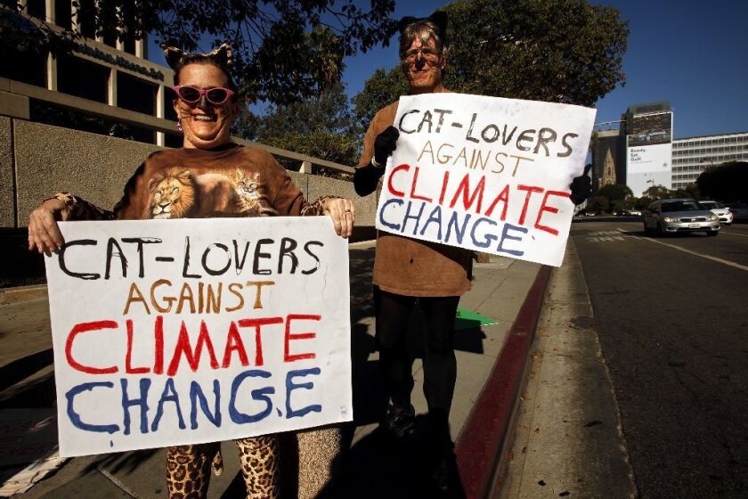 Pearl and Norm Anderson, from Pasadena, joined hundreds of climate change protesters along Wilshire Boulevard in Los Angeles on Saturday.