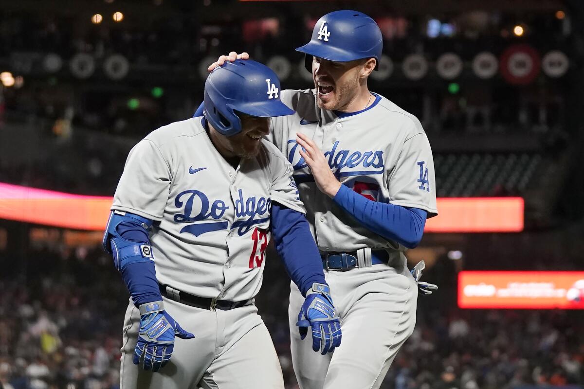 The Dodgers' Max Muncy is congratulated by Freddie Freeman after hitting a grand slam 