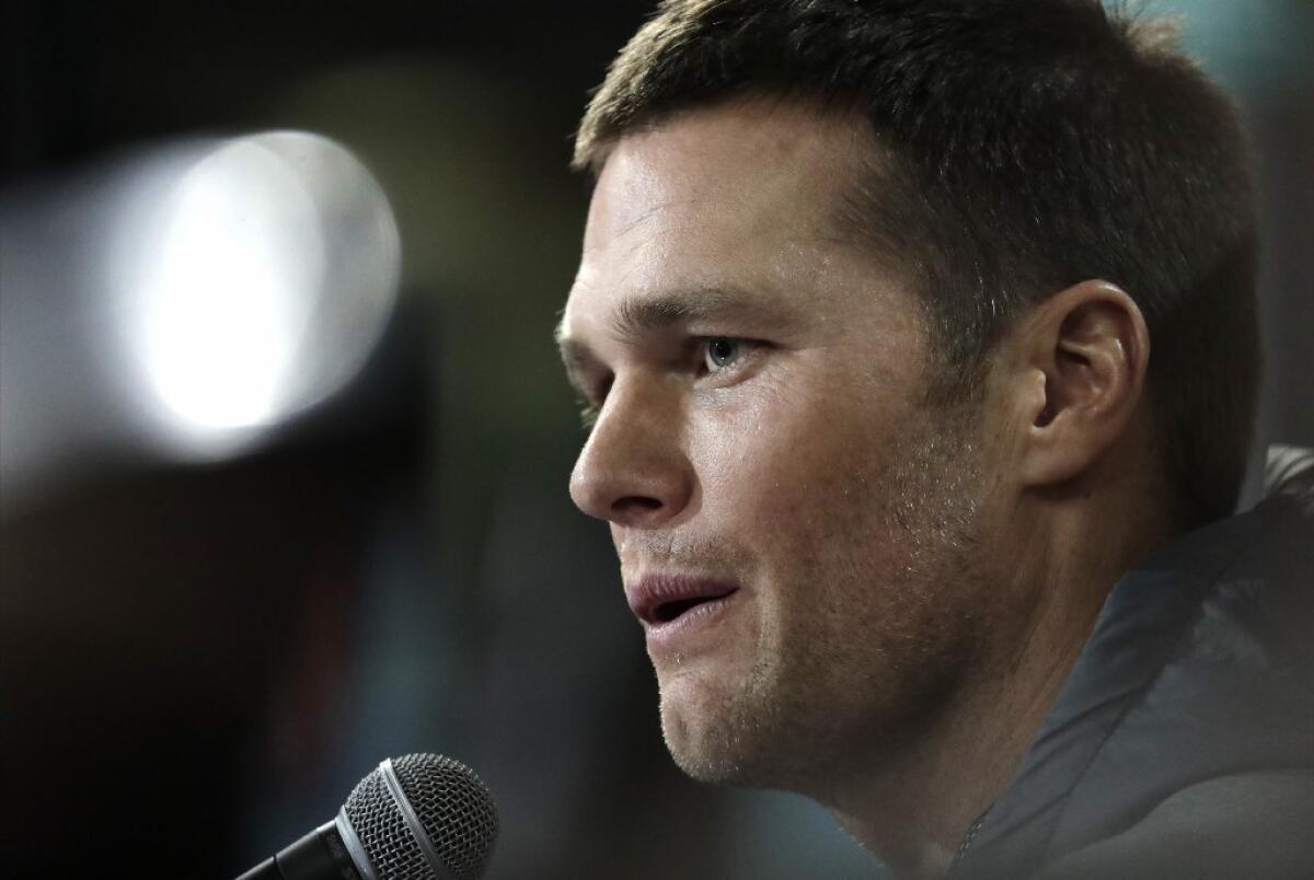 Patriots quarterback Tom Brady answers questions during opening night for Super Bowl LI at Minute Maid Park on Jan. 30.