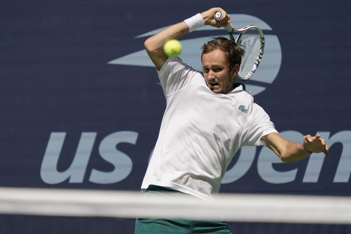 Daniil Medvedev, of Russia, returns a shot to Botic Van de Zandschulp, of the Netherlands, during the quarterfinals of the US Open tennis championships, Tuesday, Sept. 7, 2021, in New York. (AP Photo/Elise Amendola)