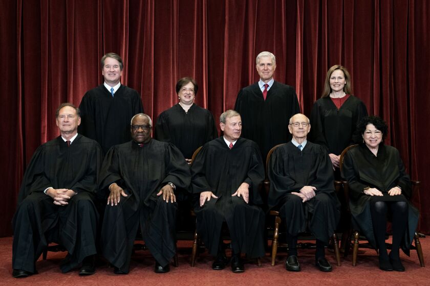 In this April 23, 2021, file photo, members of the Supreme Court pose for a group photo at the Supreme Court in Washington. Seated from left are Associate Justice Samuel Alito, Associate Justice Clarence Thomas, Chief Justice John Roberts, Associate Justice Stephen Breyer and Associate Justice Sonia Sotomayor, Standing from left are Associate Justice Brett Kavanaugh, Associate Justice Elena Kagan, Associate Justice Neil Gorsuch and Associate Justice Amy Coney Barrett. The Supreme Court is wrapping up its first all-virtual term, with decisions expected in a key case on voting rights and another involving information California requires charities to provide about donors. The court's last day of work Thursday, July 1, before its summer break also could include a retirement announcement, although the oldest of the justices, 82-year-old Stephen Breyer, has given no indication he intends to step down this year. (Erin Schaff/The New York Times via AP, Pool)