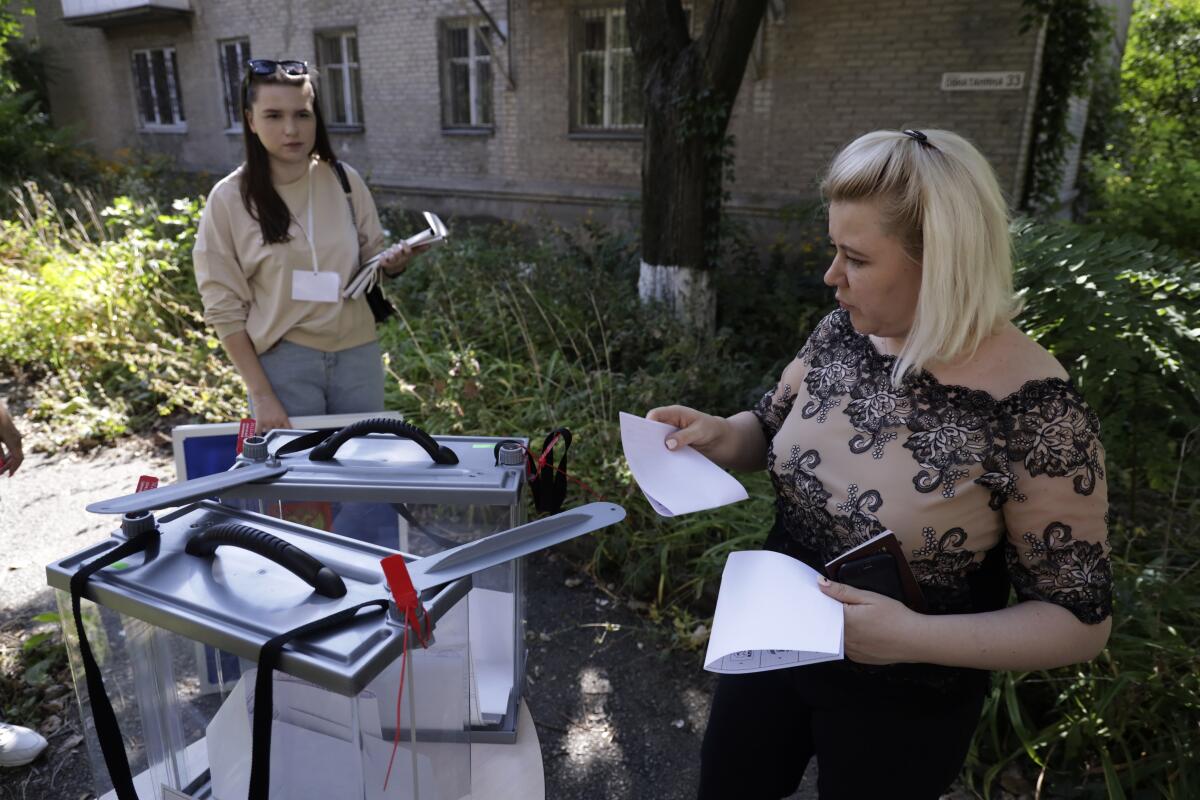 Woman casting her ballot during early voting in local elections in occupied Donetsk, eastern Ukraine