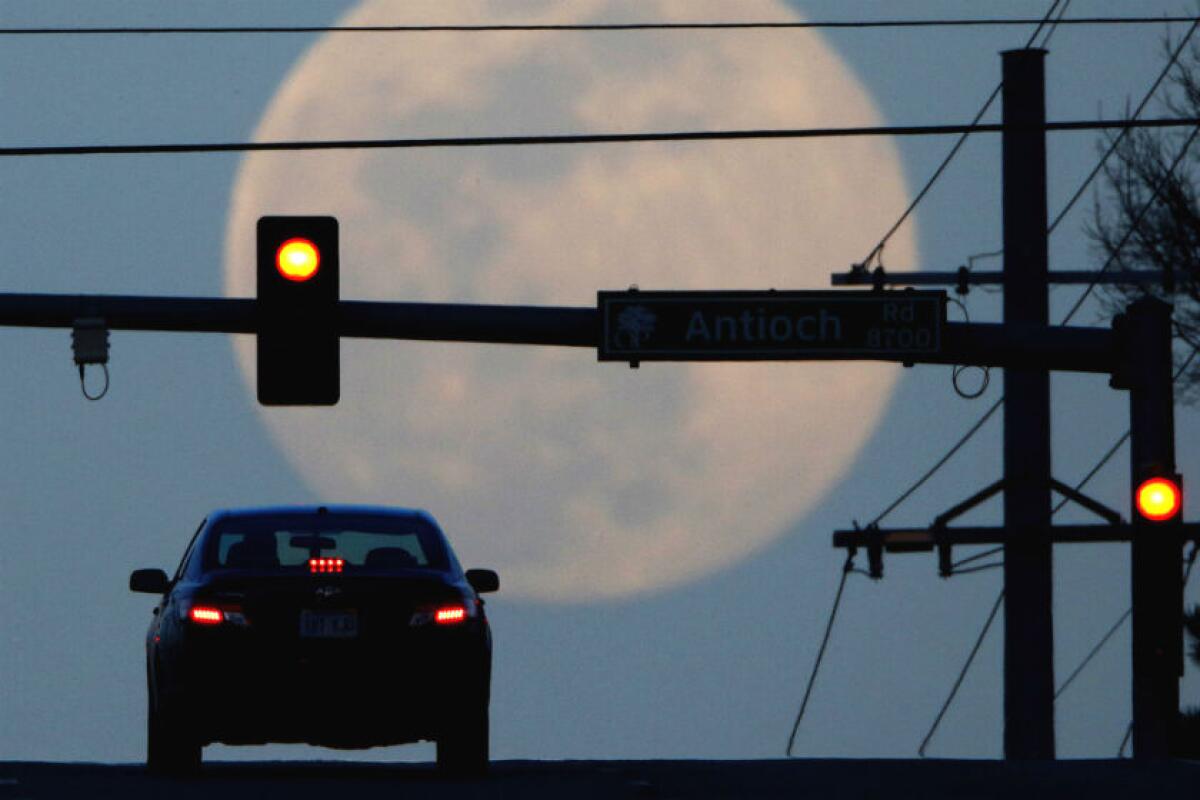 A motorist waits at a traffic light 