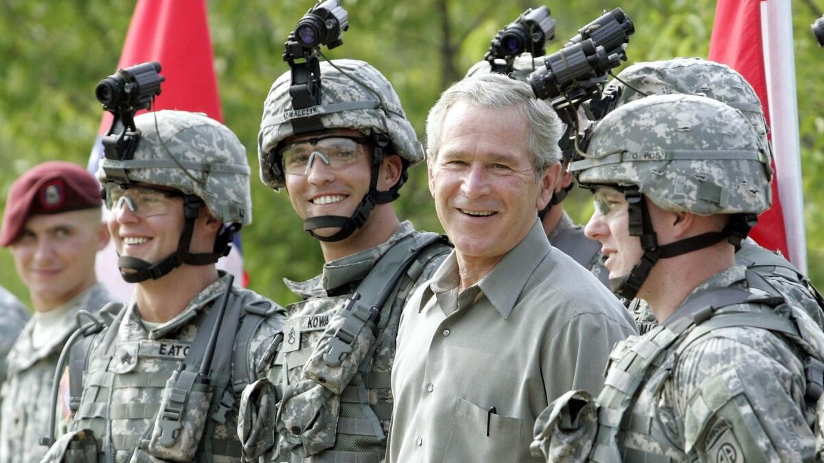 In this July 4, 2006 photo, President Bush with military personnel during his visit to U.S. Army Special Operations Command at Fort Bragg, N.C.