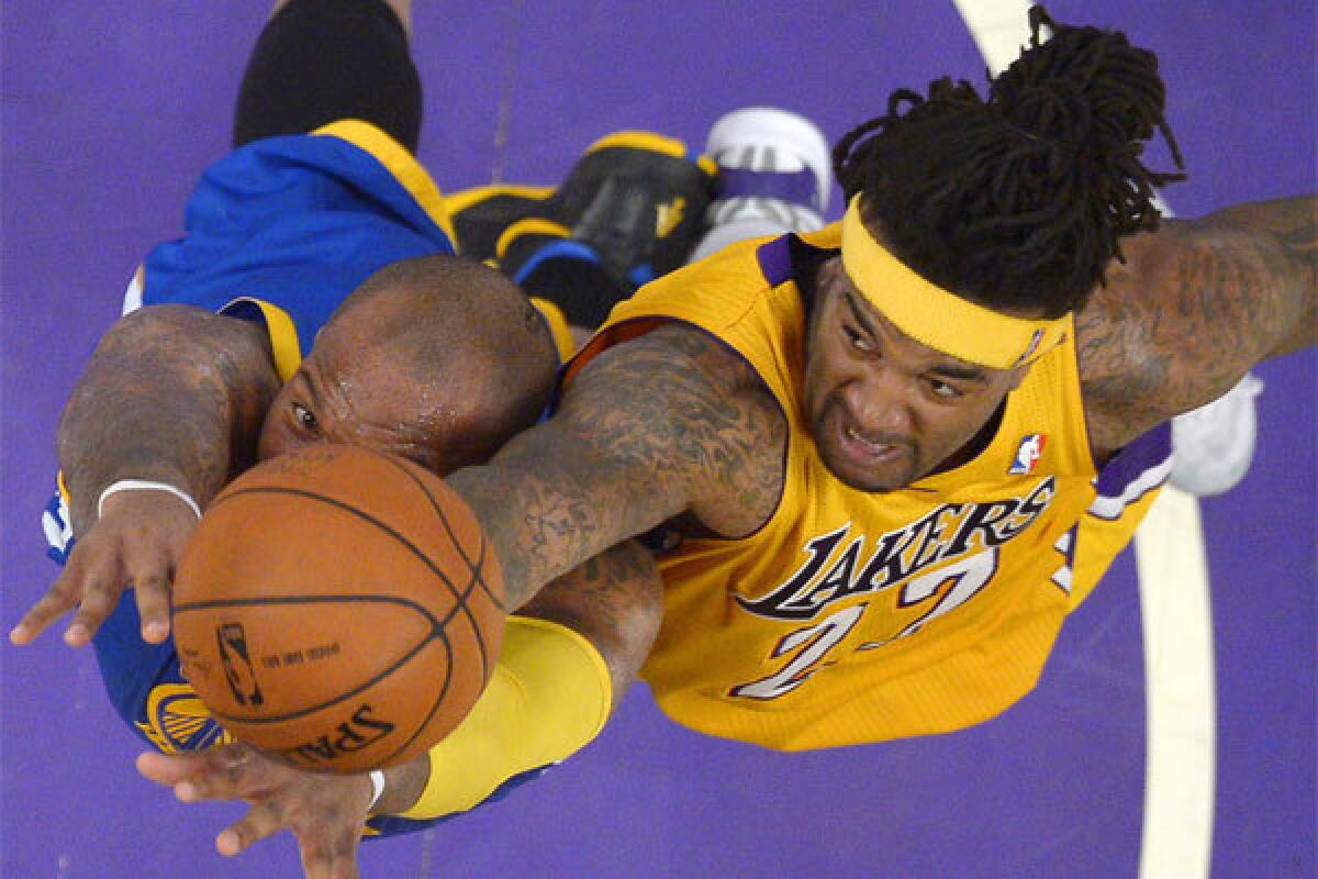 Lakers forward Jordan Hill battles Golden State forward Marreese Speights for a rebound Friday at Staples Center.