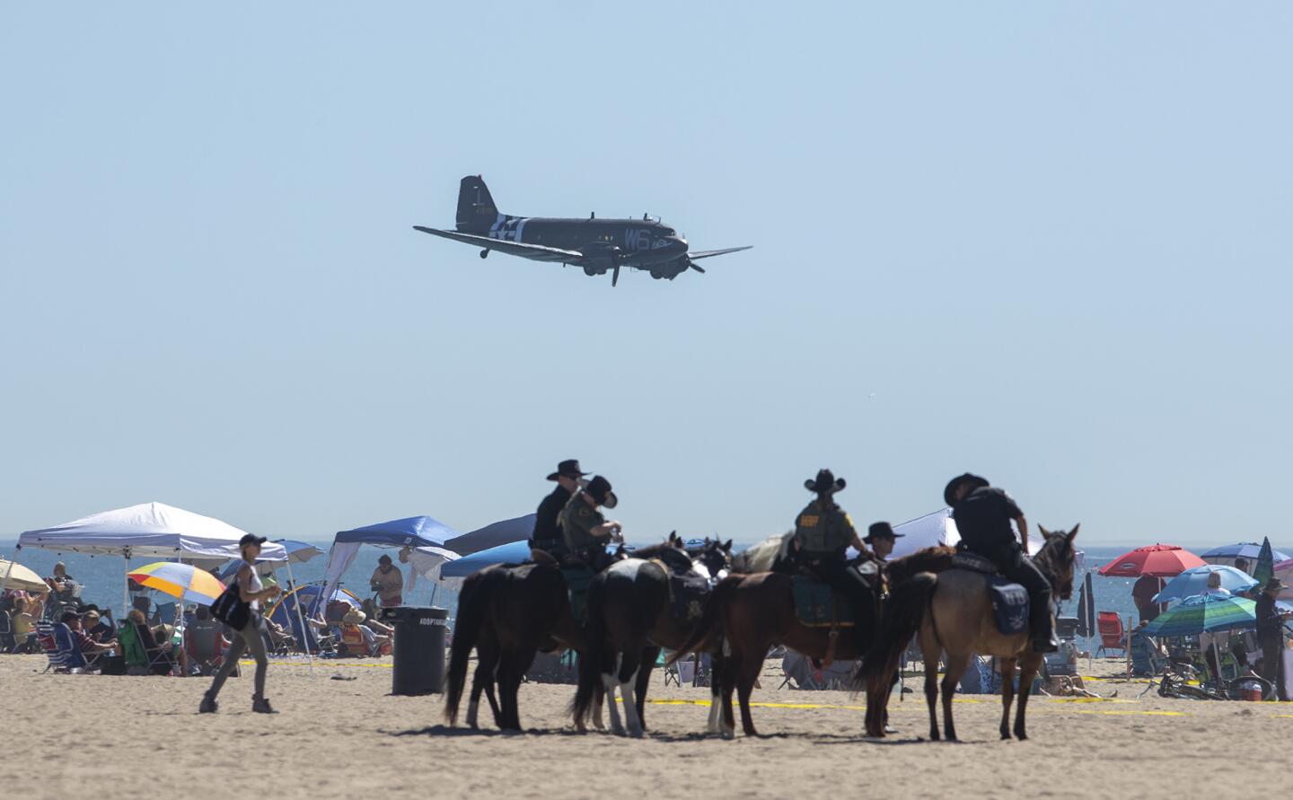 The Lyon Air MuseumÕs C-47 Dakota flys over the crowd during day one of The Great Pacific Airshow over Huntington Beach on Friday, October 19.