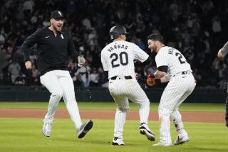 Chicago White Sox's Andrew Benintendi, right, celebrates his walk-off RBI single with Chicago White Sox outfielder Miguel Vargas, center, and Garrett Crochet, left, against the Los Angeles Angels during the tenth inning of a baseball game, Wednesday, Sept. 25, 2024, in Chicago. (AP Photo/David Banks)