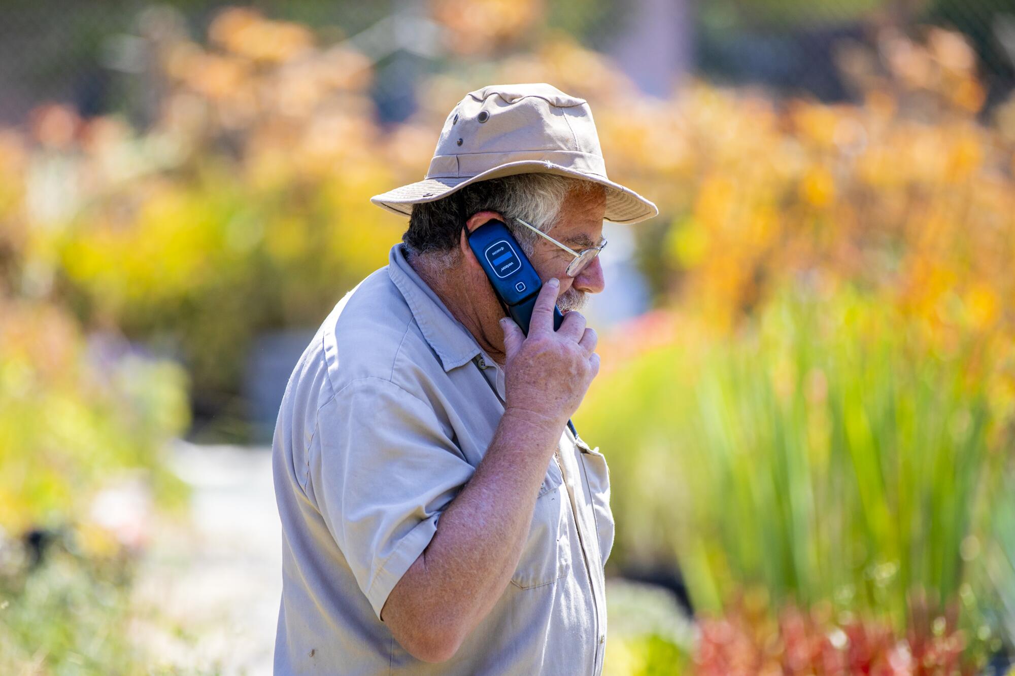 David Bernstein, owner of the Cactus Ranch, takes a call on a flip phone.