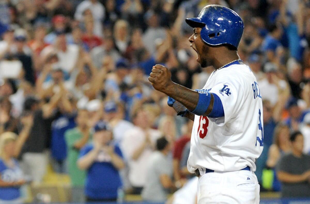 Dodgers shortstop Hanley Ramirez celebrates after scoring the winning run in the 10th inning against the Phillies on Saturday night at Dodger Stadium.