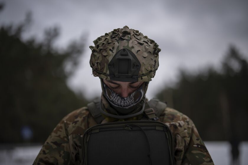 A Ukrainian serviceman controls a drone during a demonstration close to the border with Belarus, Ukraine, Wednesday, Feb. 1, 2023. Reconnaissance drones fly several times a day from Ukrainian positions across the border into Belarus, a close Russian ally, scouring for signs of trouble on the other side. Ukrainian units are monitoring the 1,000-kilometer (650-mile) frontier of marsh and woodland for a possible surprise offensive from the north, a repeat of the unsuccessful Russian thrust towards Kyiv at the start of the war nearly a year ago. (AP Photo/Daniel Cole)