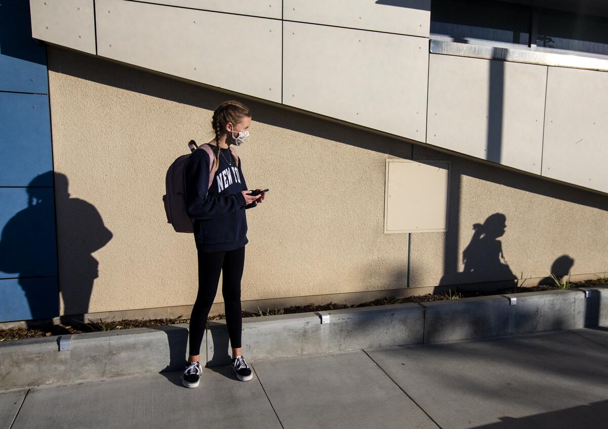 Natalie Gurney, 13, waits to be picked up at Corona Del Mar Middle School on Monday, Nov. 9.